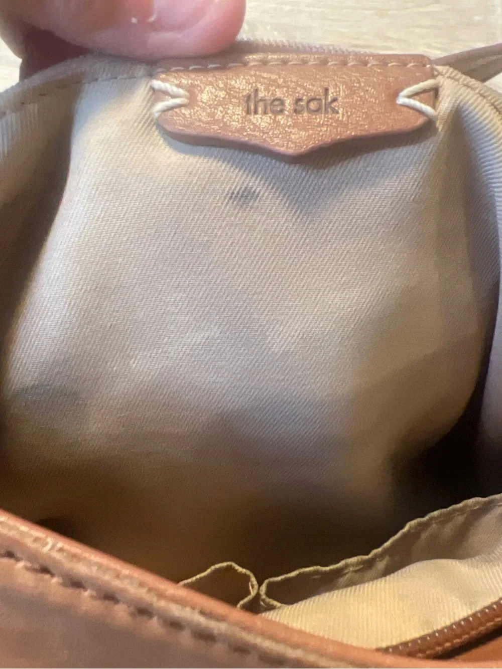 The Sak tan leather crossbody with beige interior